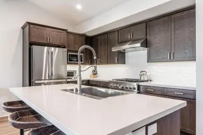 a kitchen with a white counter top and wooden cabinets at Creekhouse 1553 in Mammoth Lakes