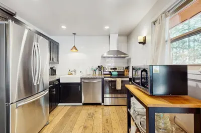 a large kitchen with stainless steel appliances and wooden floors at Golf Club Condos #437 in Truckee