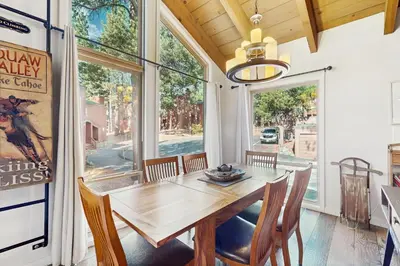 a dining room with a wooden table and chairs at Golf Club Condos #437 in Truckee