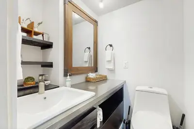 a white bathroom with a sink and a mirror at Golf Club Condos #437 in Truckee