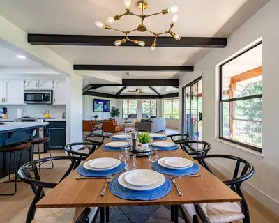 a dining room and kitchen with a wooden table and chairs at Secluded Mtn Top Family Haven w/Views Spa & Arcade in Three Rivers