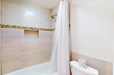a bathroom with a white shower curtain and a toilet at Horizons 4 179 in Mammoth Lakes