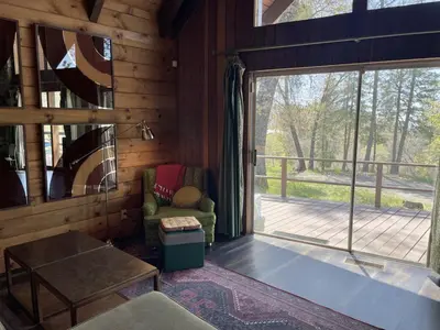 a living room with a sliding glass door to a deck at Megans Mountain Getaway in Miramonte