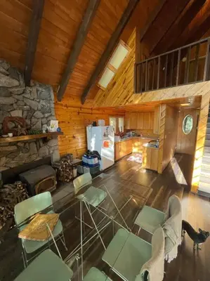 a room with chairs and a kitchen with a refrigerator at Megans Mountain Getaway in Miramonte
