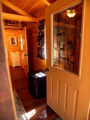 a room with a door with a window and a refrigerator at Lakeshore Resort in Lakeshore