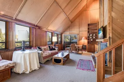 a living room with a couch and a table at Walk to the Lake - Ski in out Amazing 5 Bdrm - VH#343 in Bear Valley