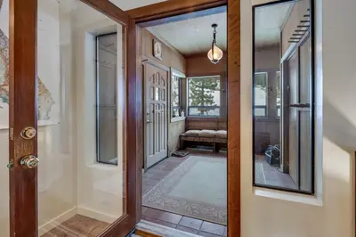 a hallway with a door and a mirror at Walk to the Lake - Ski in out Amazing 5 Bdrm - VH#343 in Bear Valley