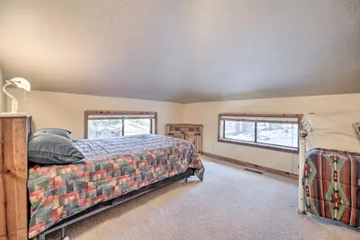 a bedroom with a bed and two windows at Shuttle to Ski Resort Northstar Home! in Truckee