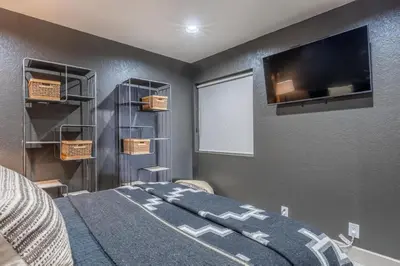 a bedroom with a bed and a flat screen tv at Bridges 112 in Mammoth Lakes