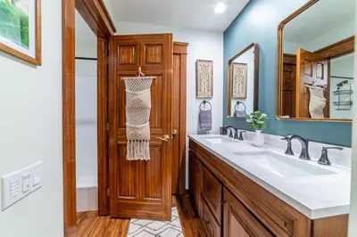 a bathroom with a sink and a wooden door at Mammoth Estates 210 in Mammoth Lakes