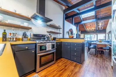 a kitchen with black appliances and a wooden floor at Mammoth Estates 210 in Mammoth Lakes