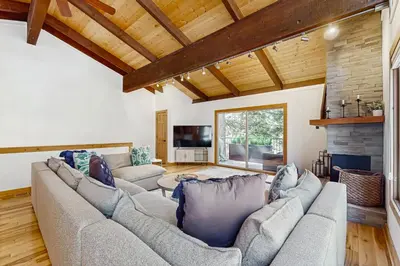 a living room with two couches and a fireplace at Retreat at Oriole Way in Incline Village