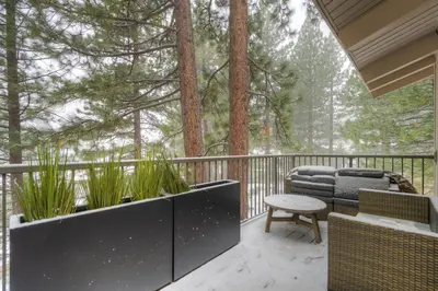 a balcony with a table and chairs and trees at Retreat at Oriole Way in Incline Village