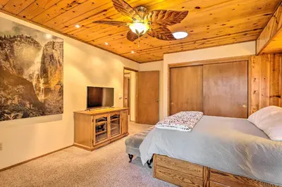 a bedroom with a bed and a ceiling fan at Deck with Forest Views Quiet Twain Harte Cabin! in Twain Harte