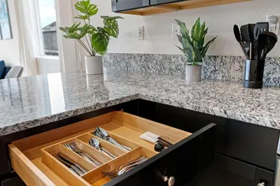 a wooden drawer in a kitchen with utensils at Stylish 4BR Home Nr Golden Eagle Sports Complex in Sparks
