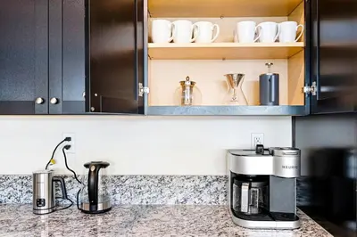 a kitchen counter with a coffee maker and cups at Stylish 4BR Home Nr Golden Eagle Sports Complex in Sparks
