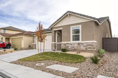 a house with a tree in front of it at Stylish 4BR Home Nr Golden Eagle Sports Complex in Sparks