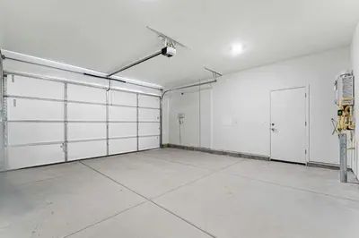 an empty garage with white walls and white doors at Stylish 4BR Home Nr Golden Eagle Sports Complex in Sparks