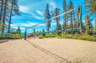 a volleyball court with a bench and a net at Lake Forest Drive Retreat in Tahoe City