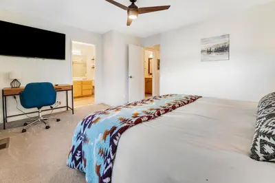 a bedroom with a bed and a desk and a television at Lake Forest Drive Retreat in Tahoe City