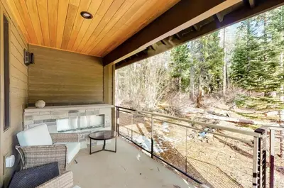 a screened in porch with a view of the woods at Gondola Vista Luxury Villas by Ski Heavenly & Beaches in South Lake Tahoe
