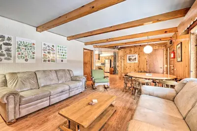 a living room with a couch and a table at 7 Mi to Yosemite Natl Park Riverfront Getaway! in Groveland