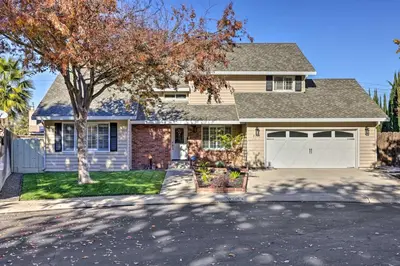 a house with a tree in front of it at Modesto Home with Deck - 2 Mi to Vintage Faire Mall in Modesto