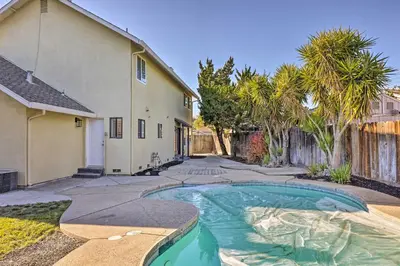 a house with a swimming pool in a yard at Modesto Home with Deck - 2 Mi to Vintage Faire Mall in Modesto