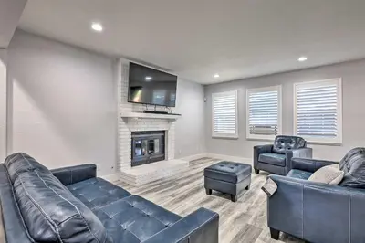 a living room with two leather couches and a fireplace at Modesto Home with Deck - 2 Mi to Vintage Faire Mall in Modesto