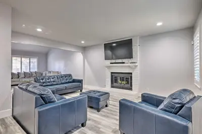 a living room with couches and a fireplace at Modesto Home with Deck - 2 Mi to Vintage Faire Mall in Modesto