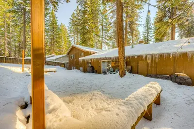 a log cabin in the snow in front of a building at Comfort is Key Cabin in Incline Village