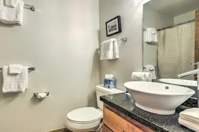 a bathroom with a sink and a toilet and a mirror at Steps to Diamond Peak Incline Village Condo in Incline Village