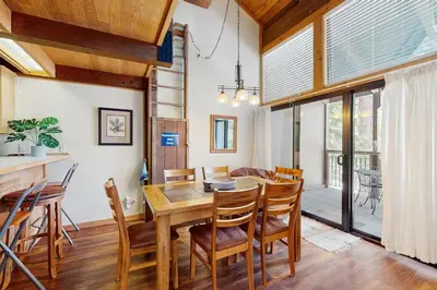 a dining room with a wooden table and chairs at Northstar's Cozy Condo in Truckee