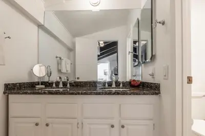 a bathroom with two sinks and a large mirror at Mammoth Ski and Racquet 71 in Mammoth Lakes