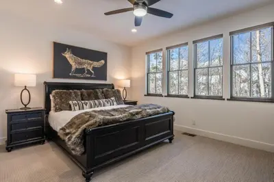 a bedroom with a bed and a ceiling fan at Creekhouse 1551 in Mammoth Lakes