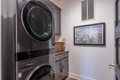 a laundry room with a washer and dryer at Creekhouse 1551 in Mammoth Lakes
