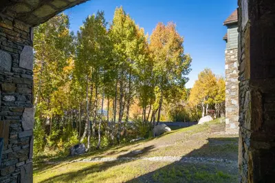 an archway in a brick building with trees in the background at Creekhouse 1551 in Mammoth Lakes