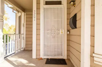 a front door of a house with a porch at A+ 2 BR Victorian Home away from Home in Sacramento