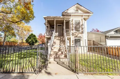 an old house with a gate in front of it at A+ 2 BR Victorian Home away from Home in Sacramento