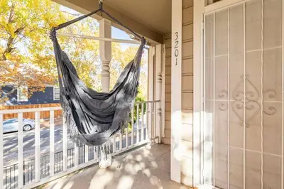 a hammock hanging on the porch of a house at A+ 2 BR Victorian Home away from Home in Sacramento