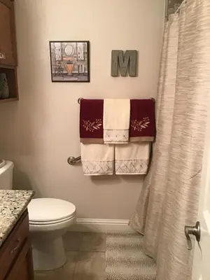 a bathroom with towels hanging on a shower curtain at Clovis, CA National Parks Room in Clovis