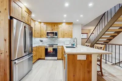 a kitchen with a stainless steel refrigerator and wooden cabinets at Lake Tahoe Leisure in Carnelian Bay