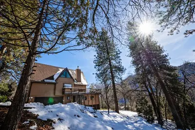 a house in the woods in the snow at Hygge Haus Sequoia - Large Private Cabin w Views in Ponderosa