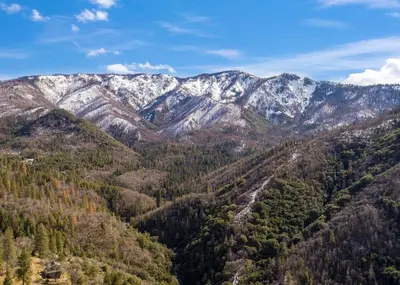 an aerial view of a mountain range with snow covered mountains at Hygge Haus Sequoia - Large Private Cabin w Views in Ponderosa