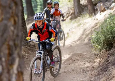 a group of people riding bikes on a dirt trail at Cozy Northstar Village Family Condo Walk to Lifts 2 Full BA Excellent Location in Truckee