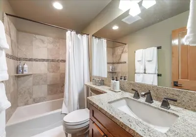 a bathroom with a sink and a tub and a toilet at Cozy Northstar Village Family Condo Walk to Lifts 2 Full BA Excellent Location in Truckee
