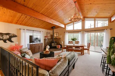 a living room with a couch and a table at Hot Tub and Scenic Views Luxury Twain Harte Cabin! in Twain Harte