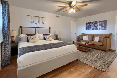 a bedroom with a large bed and a couch at NEW! Yosemite Mountain villa, stunning views -more in Oakhurst