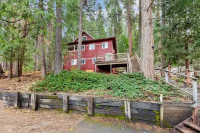 a red house in the middle of the forest at Vacation Valhalla in Arnold