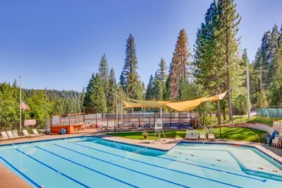 a swimming pool in a yard with trees at Vacation Valhalla in Arnold